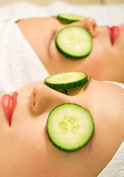 istock Two girls lying down with cucumbers on their eyes 92051693