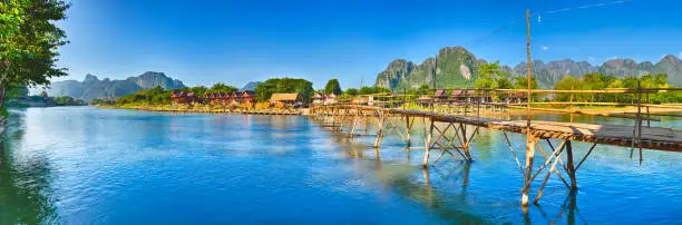 Photo of Beautiful view of a bamboo bridge. Laos landscape. Panorama