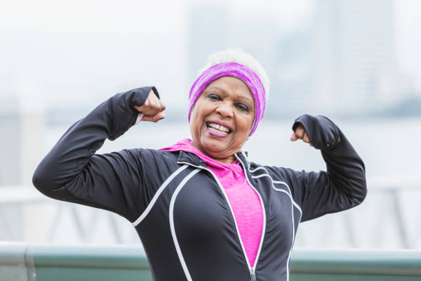 istock Senior African-American woman outdoors, flexing muscles 920522262