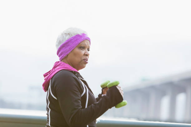 Senior African-American woman exercising, hand weights