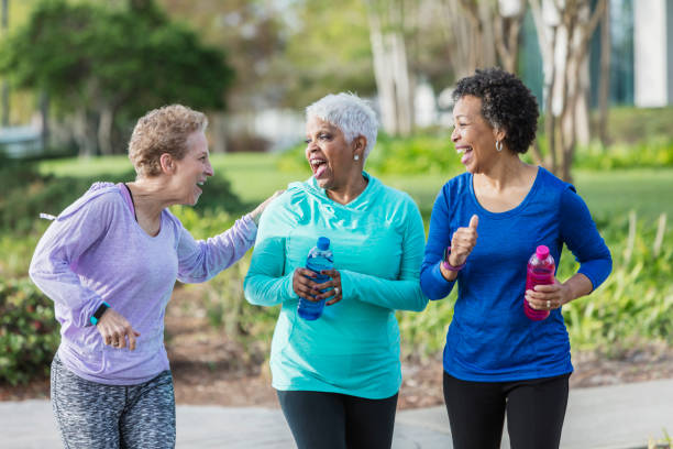 istock Three mature women exercising in park, walking, talking 920524810
