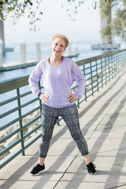 istock Senior woman exercising on city waterfront 920524942