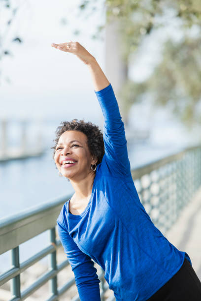 istock Mature African-American woman exercising on waterfront 920524972