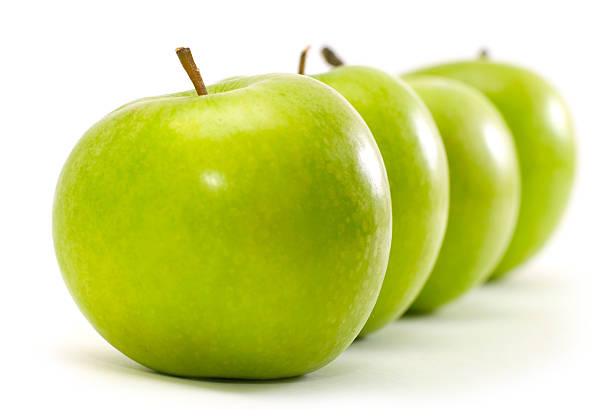 istock Four green apples in a straight line on a white background 92052794