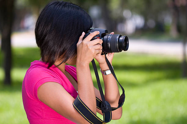 istock Young beautiful  woman holding a photo camera. 92053027