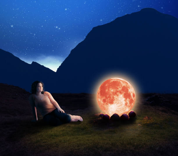 istock Woman contemplating next to the moon 920534202
