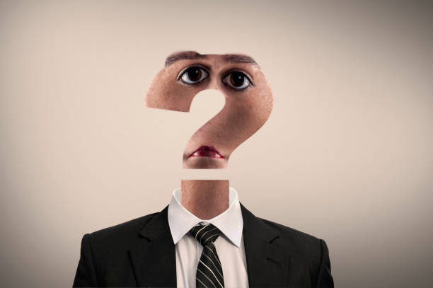 istock Business man with his head shaped as a question mark sugesting confusion. 920534218
