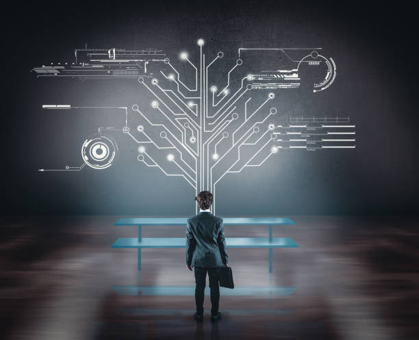 istock Businessman watching circuit board tree in the office. Network concept. 920534336