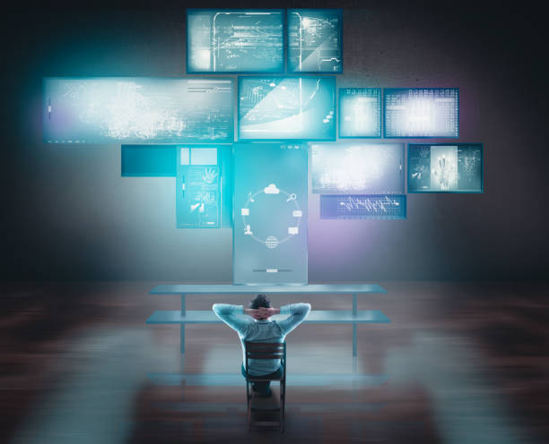istock Businessman watching touch screens and computers on desk. 920534504