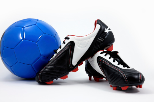 Soccer ball and cleats shot on white background