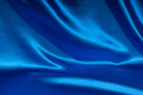 Blue satin fabric with creases background closeup view of blue satin perfect for abstract background. royal blue curtains stock pictures, royalty-free photos & images