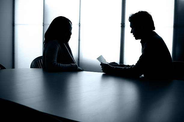 istock Back Lit People Sitting at Conference Table Office Meeting Interview 92054449