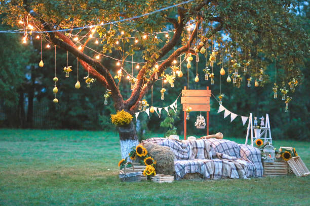 Rustic wedding photo zone. Hand made wedding decorations includes Photo Booth, wooden barrels and boxes, lanterns, suitcases and white flowers