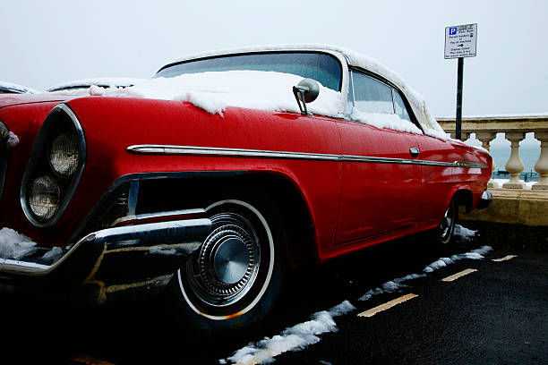 Vintage muscle car convertible in snowy winter parking lot landscape