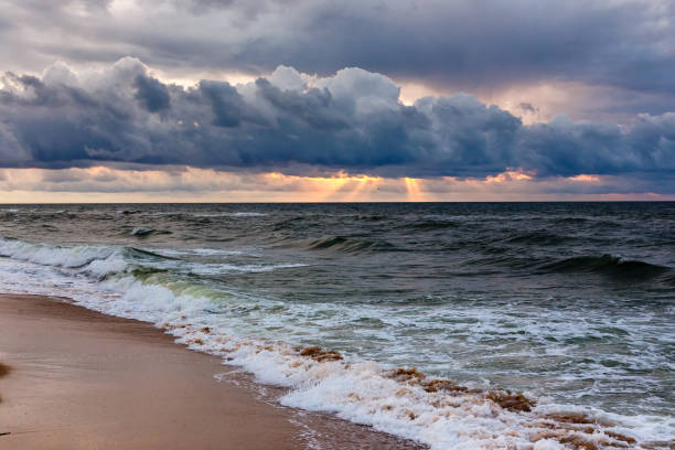 istock Dramatic sky on a morning seascape. Storm on a sandy sea beach. 920555036