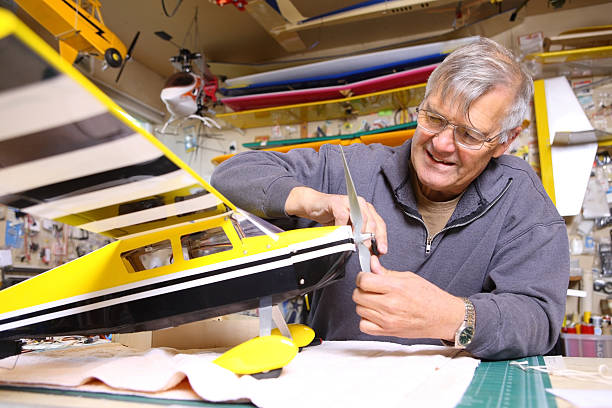 Senior man working on model airplane  toy airplane stock pictures, royalty-free photos & images