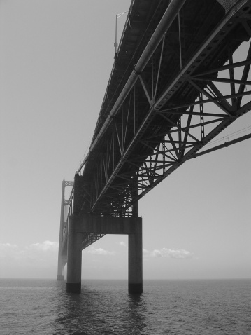 A view of the Mackinac Bridge from the northern anchor pier in black and white.  The Mackinac Bridge spans the Mackinac Strait where Lake Michigan meets Lake Huron.  It links Michigan's Upper and Lower Peninsulas.  June 2003.