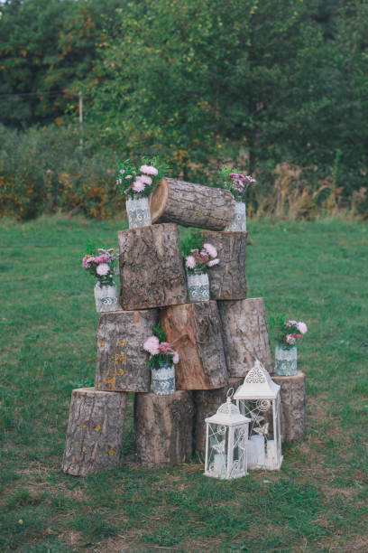 istock Rustic wedding photo zone. Hand made wedding decorations includes Photo Booth, wooden barrels and boxes, lanterns, suitcases and white flowers 920563770