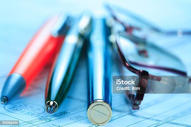 Writing Tools And Eyeglases In Blue Stock Photo - Download Image Now - Architect, Architecture, Blueprint