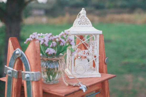 istock Rustic wedding photo zone. Hand made wedding decorations includes Photo Booth, wooden barrels and boxes, lanterns, suitcases and white flowers 920565366