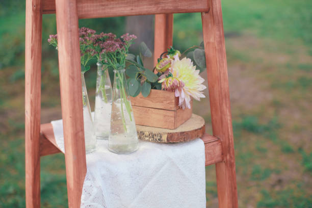 istock Rustic wedding photo zone. Hand made wedding decorations includes Photo Booth, wooden barrels and boxes, lanterns, suitcases and white flowers 920565812
