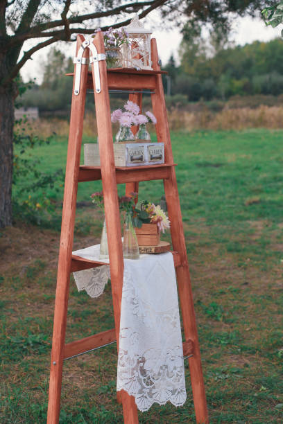 istock Rustic wedding photo zone. Hand made wedding decorations includes Photo Booth, wooden barrels and boxes, lanterns, suitcases and white flowers 920565814