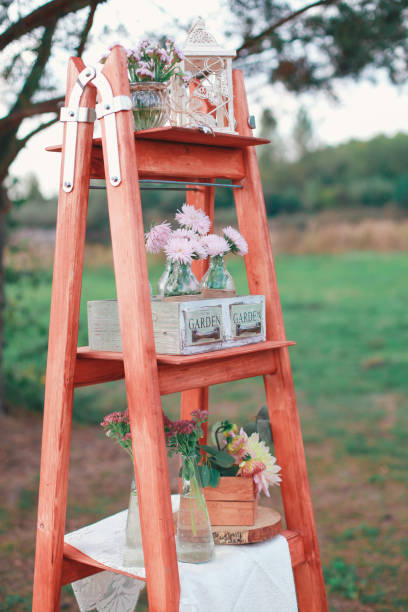 istock Rustic wedding photo zone. Hand made wedding decorations includes Photo Booth, wooden barrels and boxes, lanterns, suitcases and white flowers 920565820