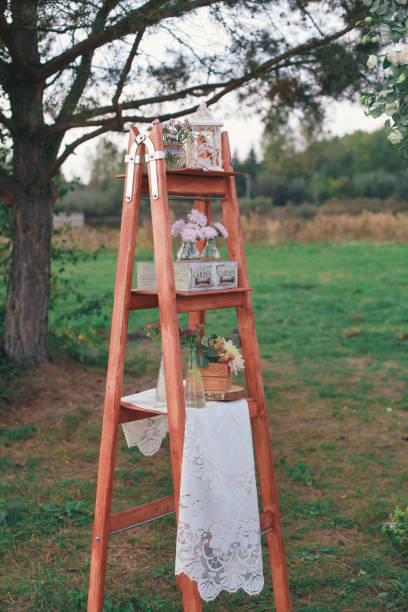 istock Rustic wedding photo zone. Hand made wedding decorations includes Photo Booth, wooden barrels and boxes, lanterns, suitcases and white flowers 920565822