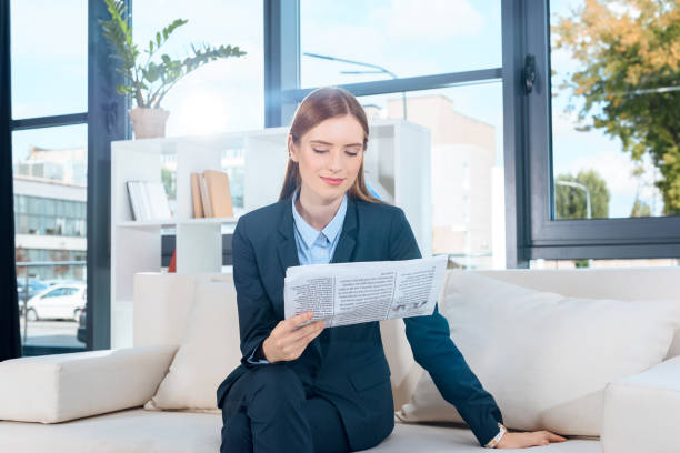 istock businesswoman reading newspaper 920567944