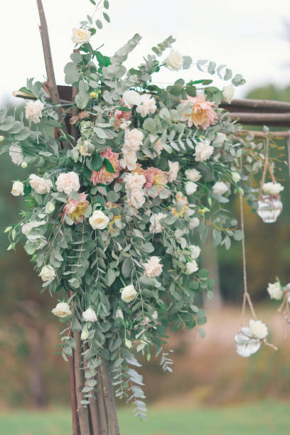 istock Rustic wedding photo zone. Hand made wedding decorations includes Photo Booth, wooden barrels and boxes, lanterns, suitcases and white flowers 920567954