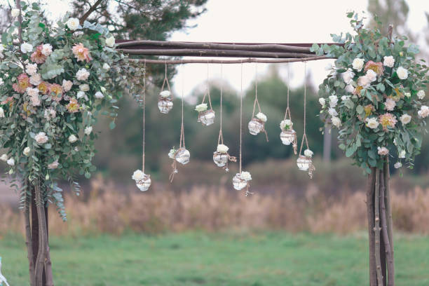 istock Rustic wedding photo zone. Hand made wedding decorations includes Photo Booth, wooden barrels and boxes, lanterns, suitcases and white flowers 920567982