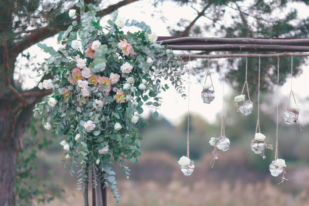 istock Rustic wedding photo zone. Hand made wedding decorations includes Photo Booth, wooden barrels and boxes, lanterns, suitcases and white flowers 920568524