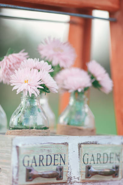 istock Rustic wedding photo zone. Hand made wedding decorations includes Photo Booth, wooden barrels and boxes, lanterns, suitcases and white flowers 920570050