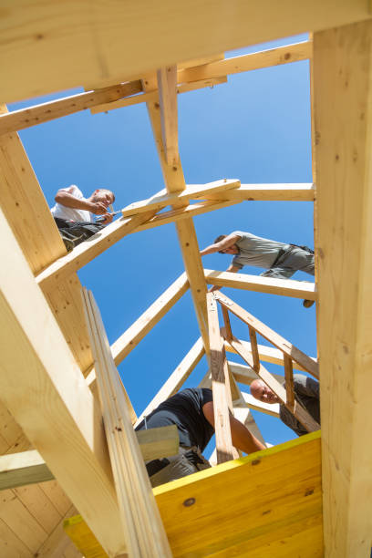 istock Builders at work with wooden roof construction. 920578508