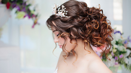 Portrait of a beautiful girl in a wedding dress. Bride in luxurious dress, close-up