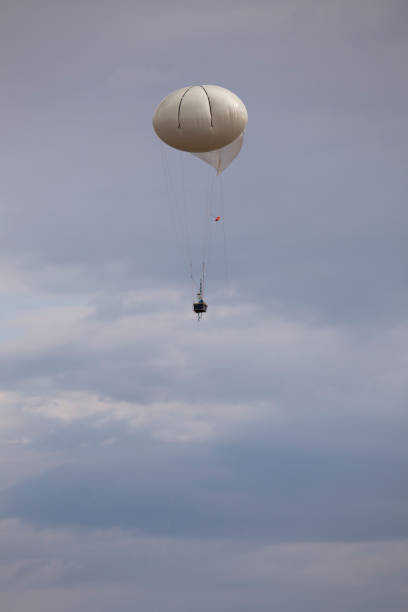 Tethered air quality testing NASA weather balloon Golden Colorado In Golden Colorado, a tethered NASA weather balloon for testing national air quality slowly rises into the sky by prepared by students of Meteorology at Millersville University. weather balloon stock pictures, royalty-free photos & images