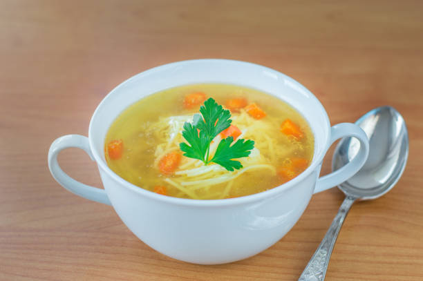 istock Traditional Polish chicken broth with carrot parsley and spoon. 920583868