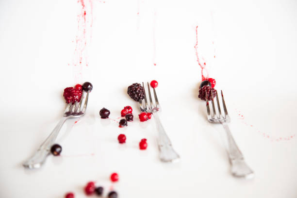 istock forest fruits with white background forming a composition with three forks and fruits of blackberry and frozen blueberries that melt staining the background 920584564