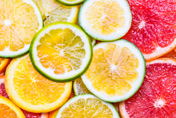 istock Fresh citrus fruits sliced assortment top view flat lay background. 920584680