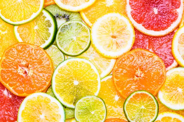 Photo of Fresh citrus fruits sliced assortment top view flat lay background.