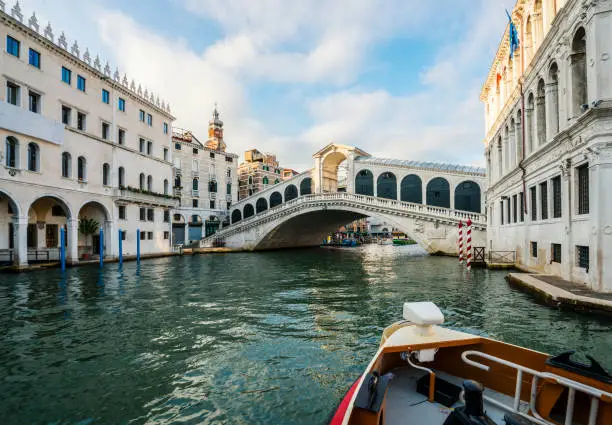 Boat On Grand Canal near famous Grand Rialto Bridge, Venice, Italy