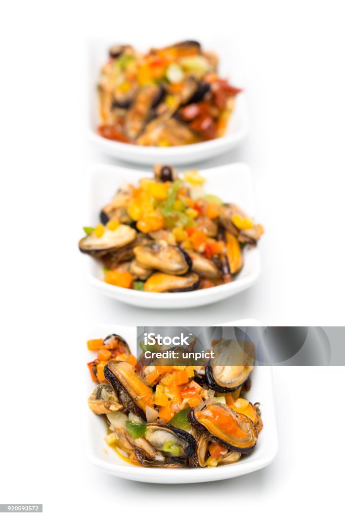 fish and seafood: 3 cups of mussels isolated on white background real edible food - no artificial ingredients used Marinated Stock Photo