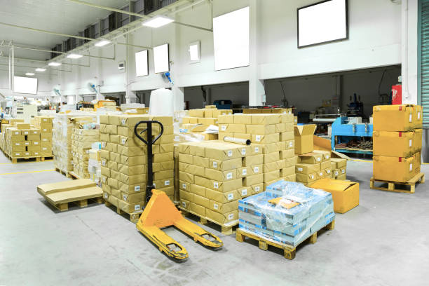 istock Interior of a warehouse with manual forklift pallet stacker truck equipment, boxes. 920593836