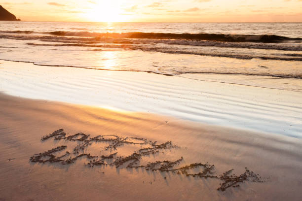 istock happy birthday on sand beach 920600072
