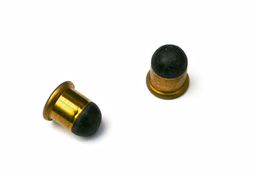 Close-up on two .22 BB caps, a variety of .22 caliber (5.6 mm) rimfire ammunition.