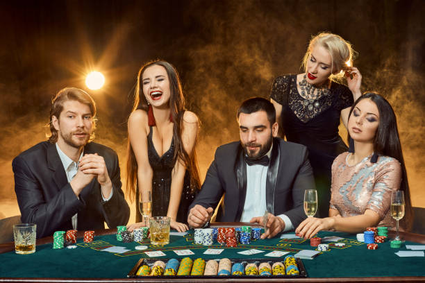 istock Poker players sitting around a table at a casino 920603152
