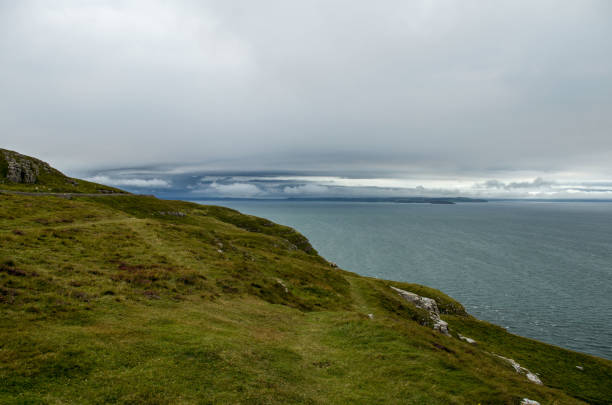 istock Dramatic sky over ocean on edge of cliff. Wales. 920616916