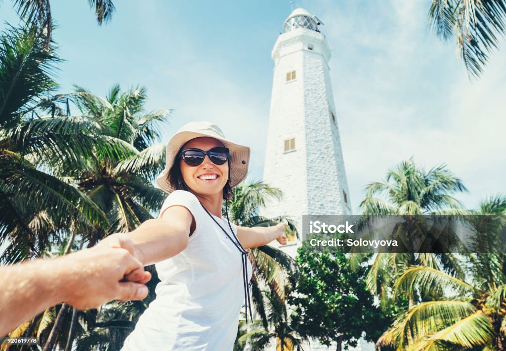 Dondra lighthouse in Sri Lanka: woman traveler take for hand her boyfreind and goes to lighthouse Adult Stock Photo