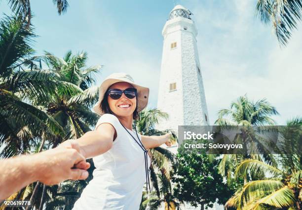 Dondra Lighthouse In Sri Lanka Woman Traveler Take For Hand Her Boyfreind And Goes To Lighthouse Stock Photo - Download Image Now