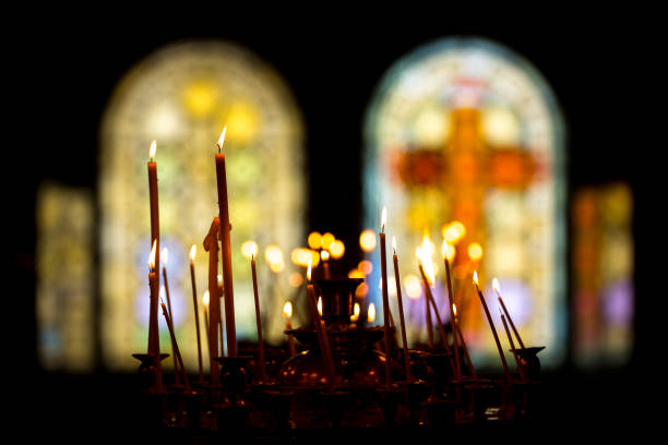 istock Stained glass windows in church and candles 920619844